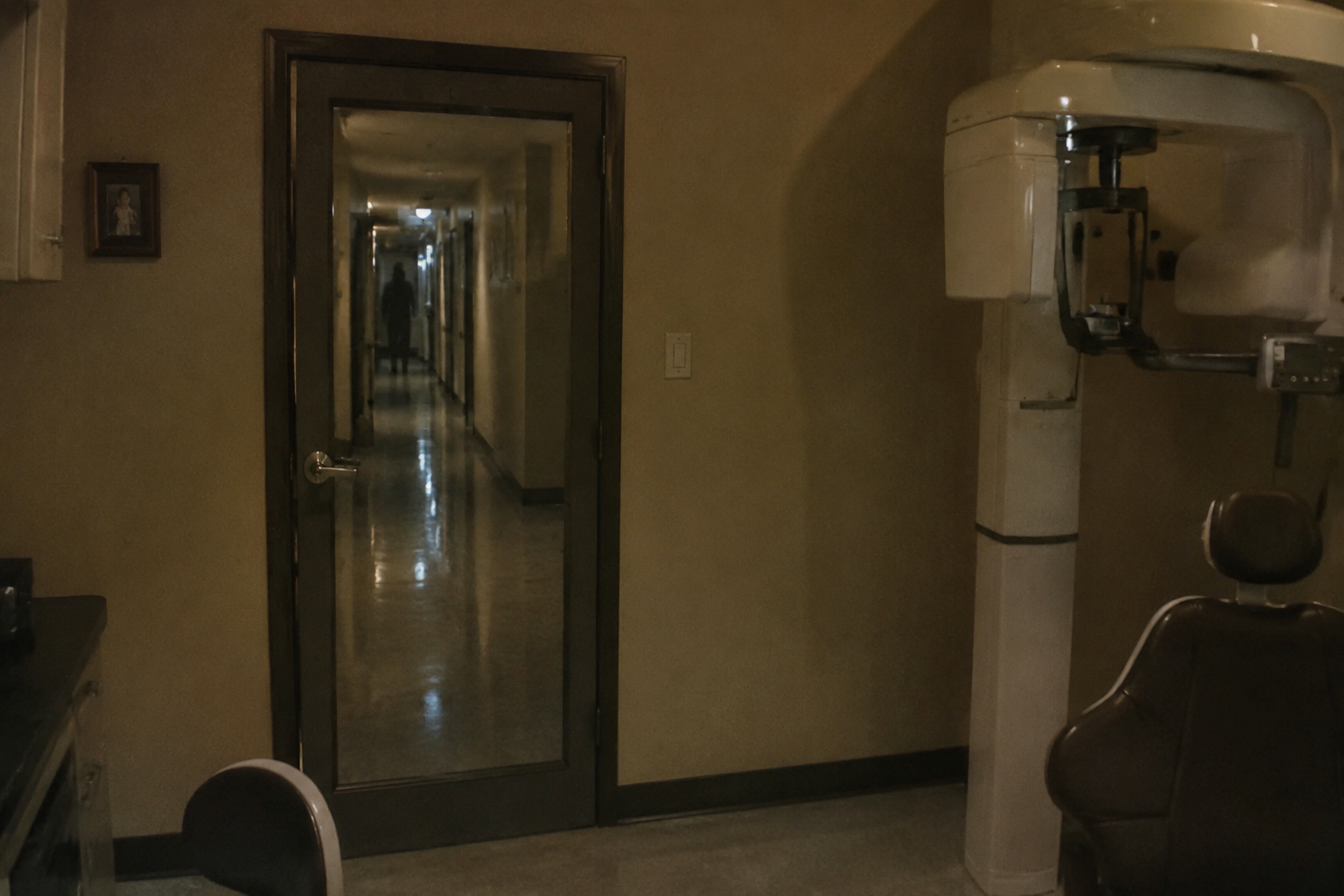 Faint figure reflected in clinic doorway