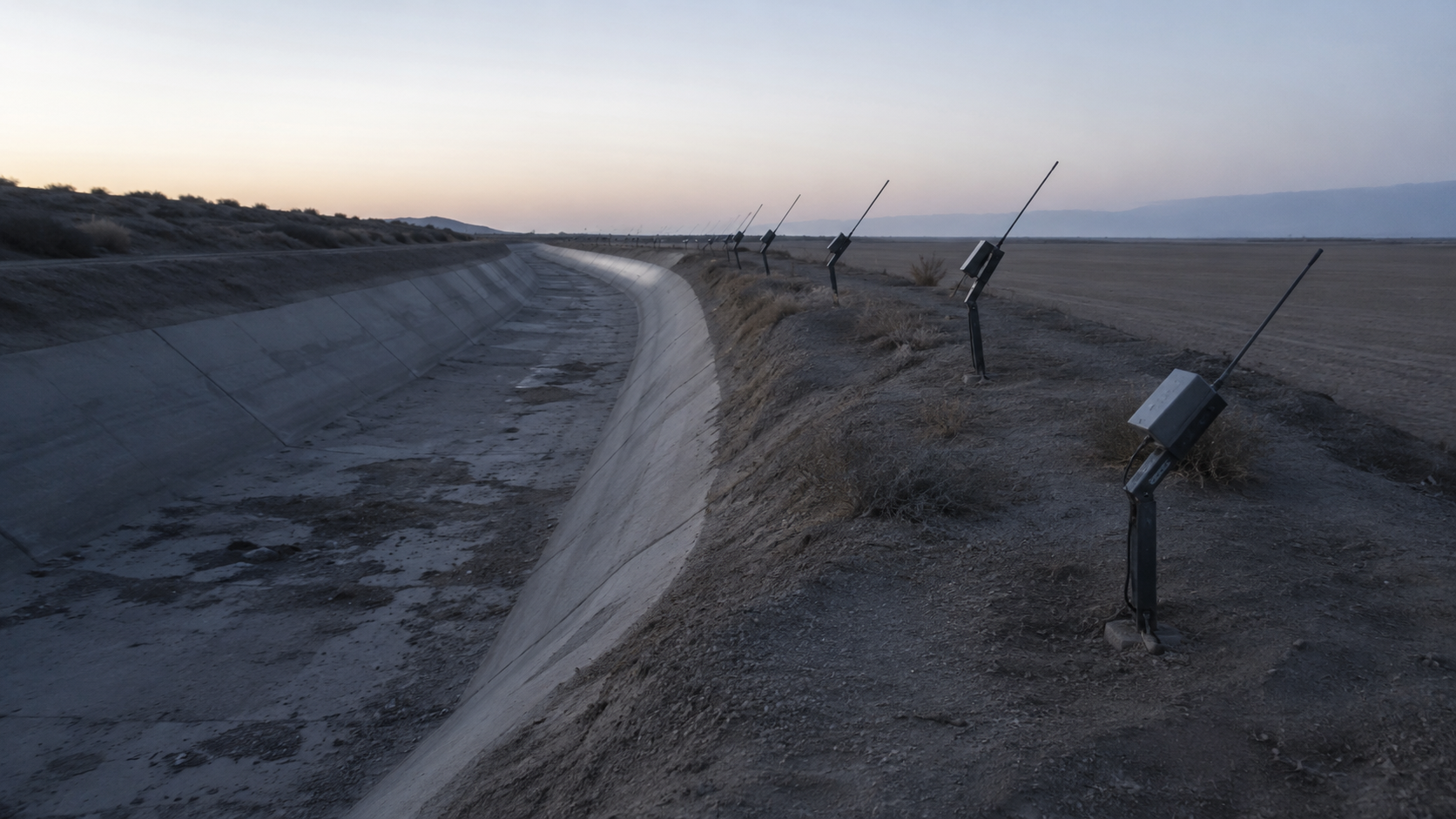 Radio poles beside a dry irrigation canal