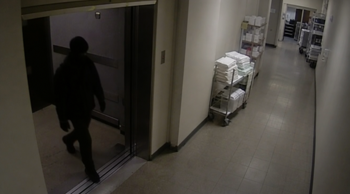 Dark figure exiting a clinic freight elevator