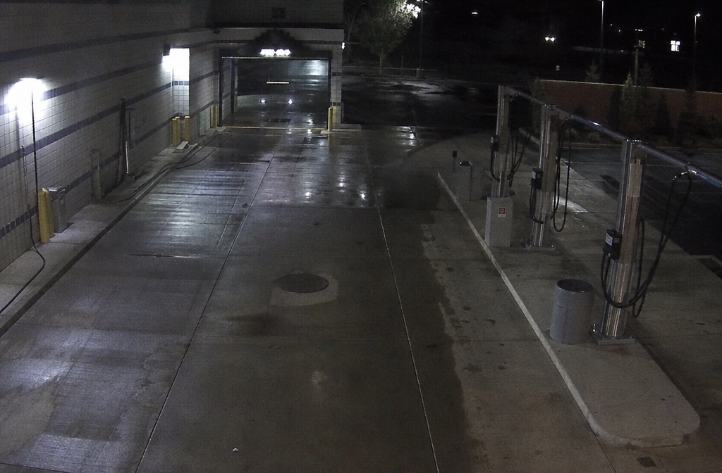 Overnight security view of empty car wash and vacuum area