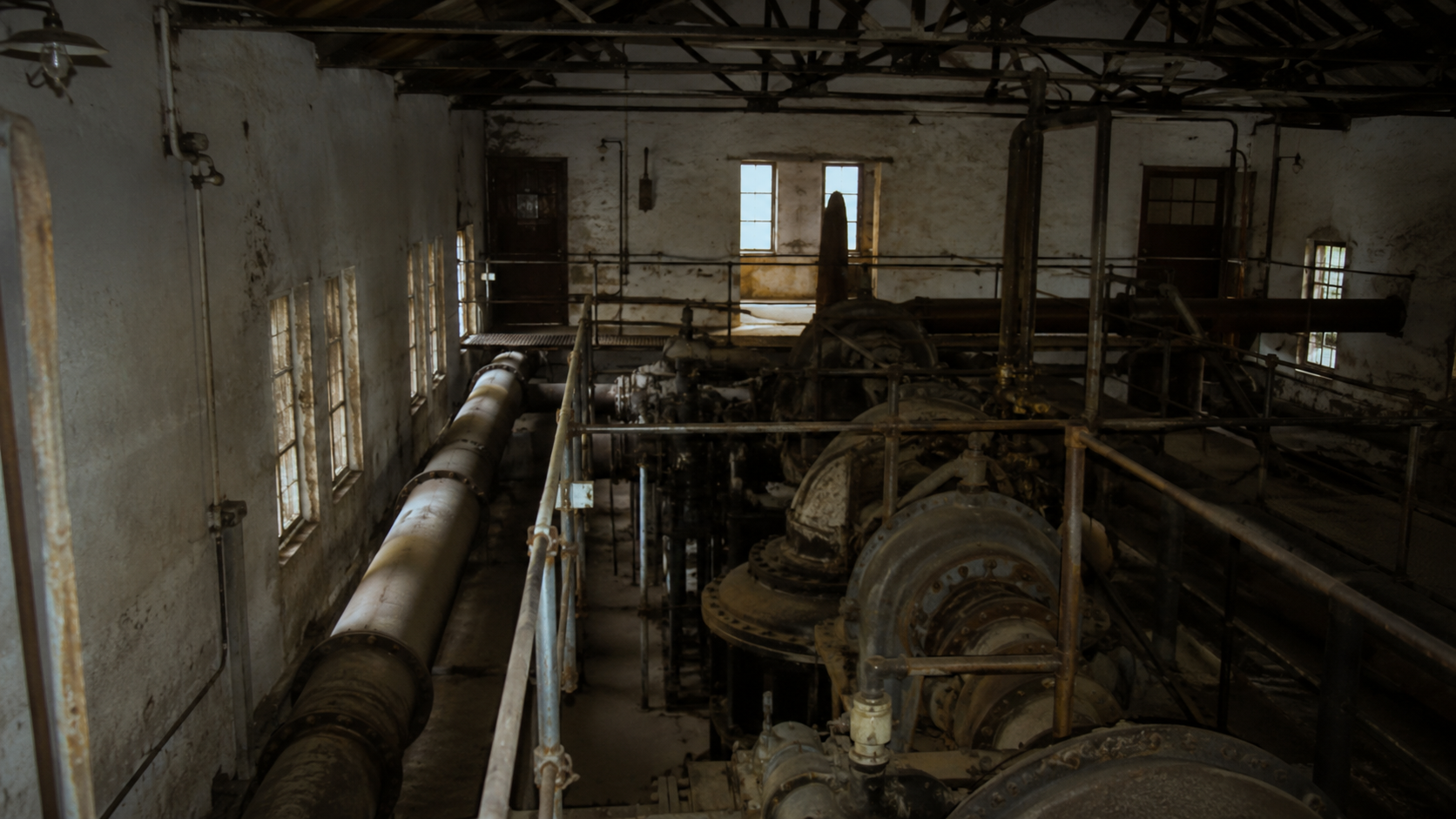 Pump house interior with pipes, railings, and a narrow ambiguous shadow near the far rail.
