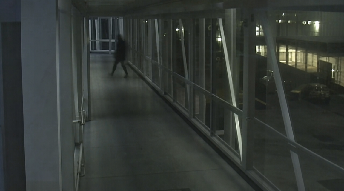 Dark figure crossing sealed ferry bridge