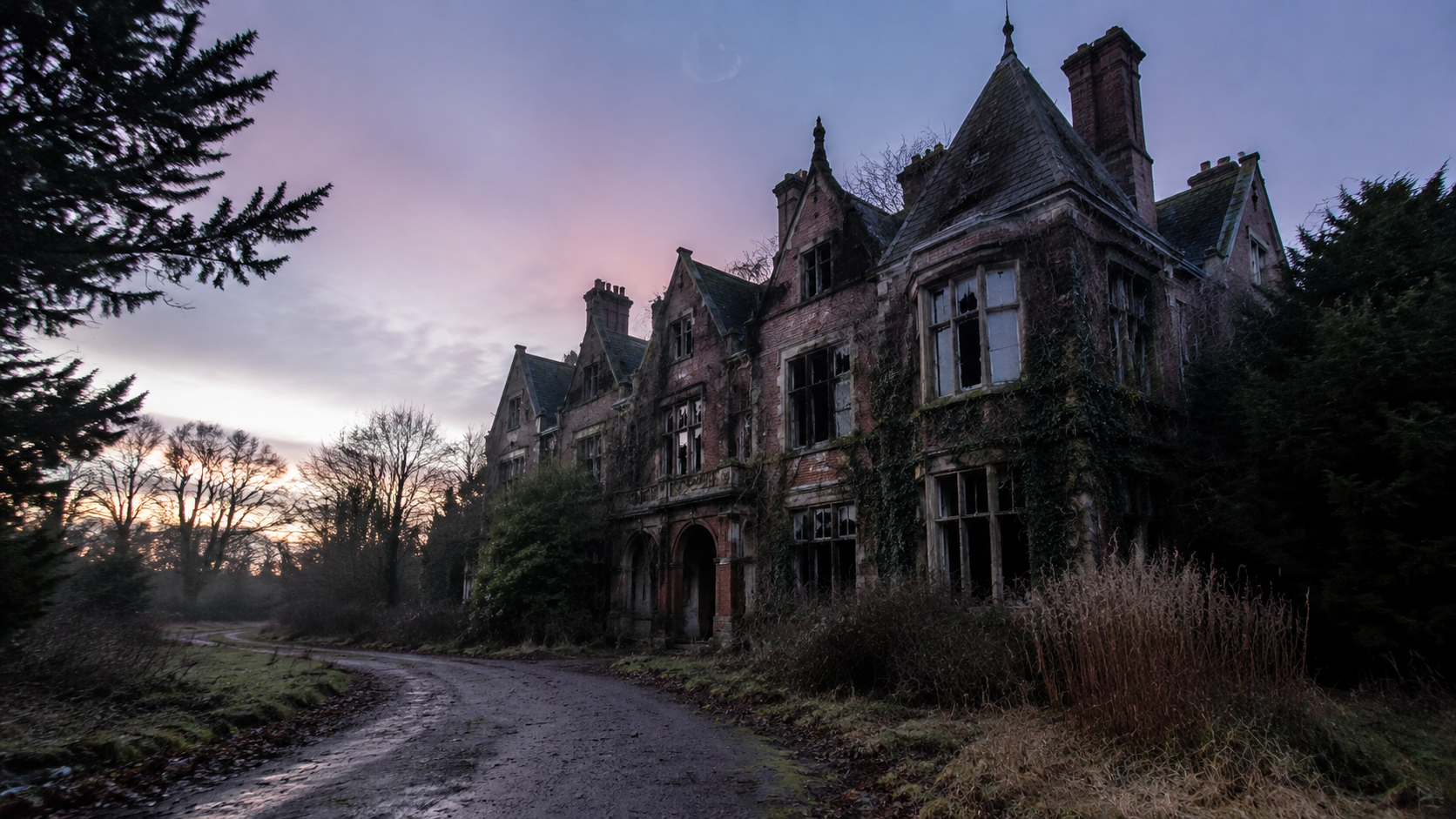 Abandoned Merrow Hall at dusk with ivy, broken windows, and an overgrown drive.
