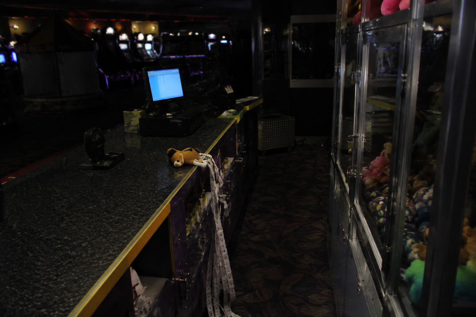 Empty arcade prize counter security view with a small plush toy out of place