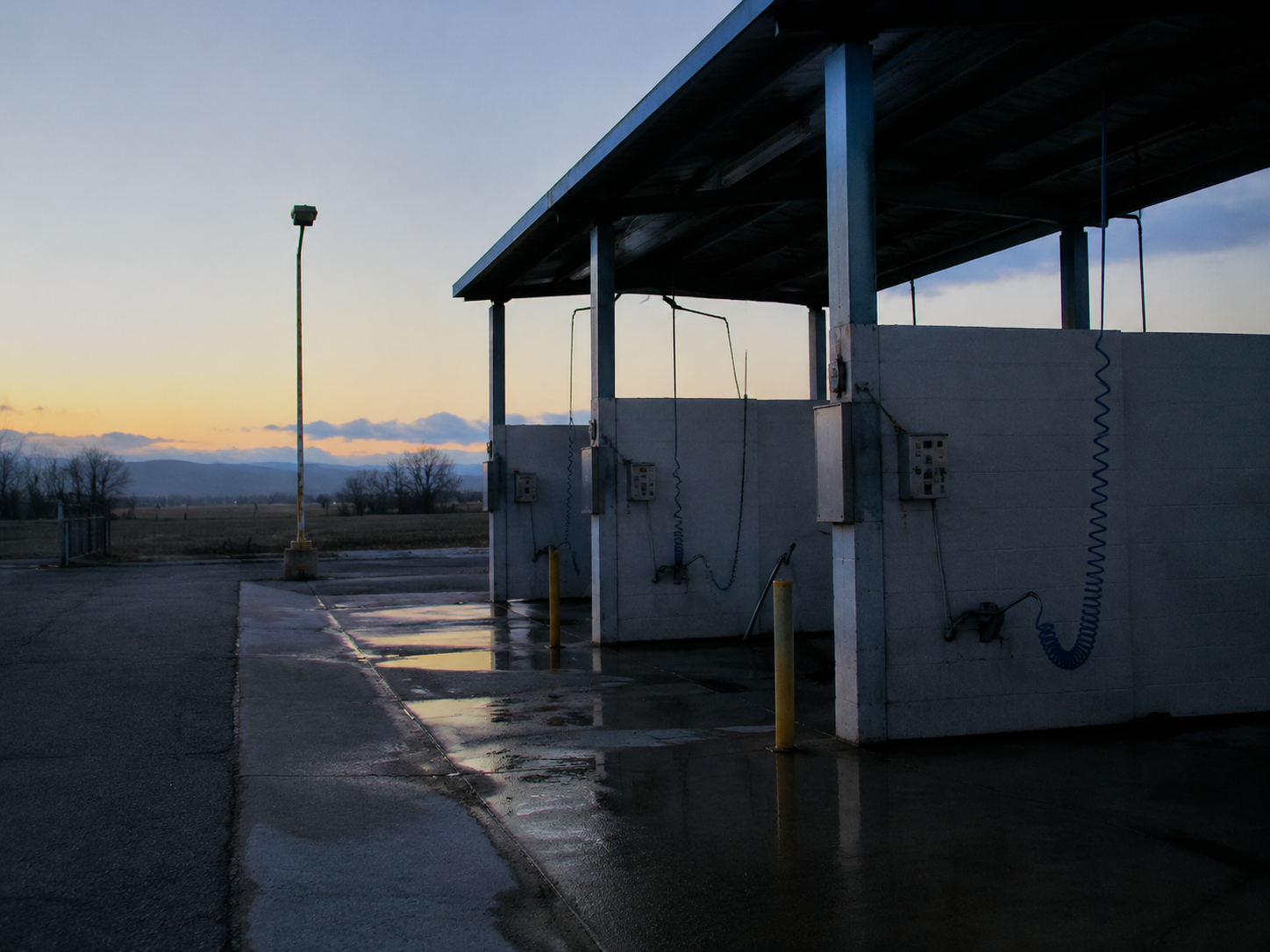 The car wash vacuum bays are empty and still the morning after the footage.