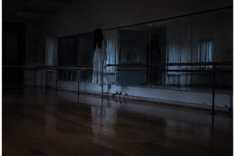 The Closed Dance Studio Mirror And The White-Dress Figure By The Barre