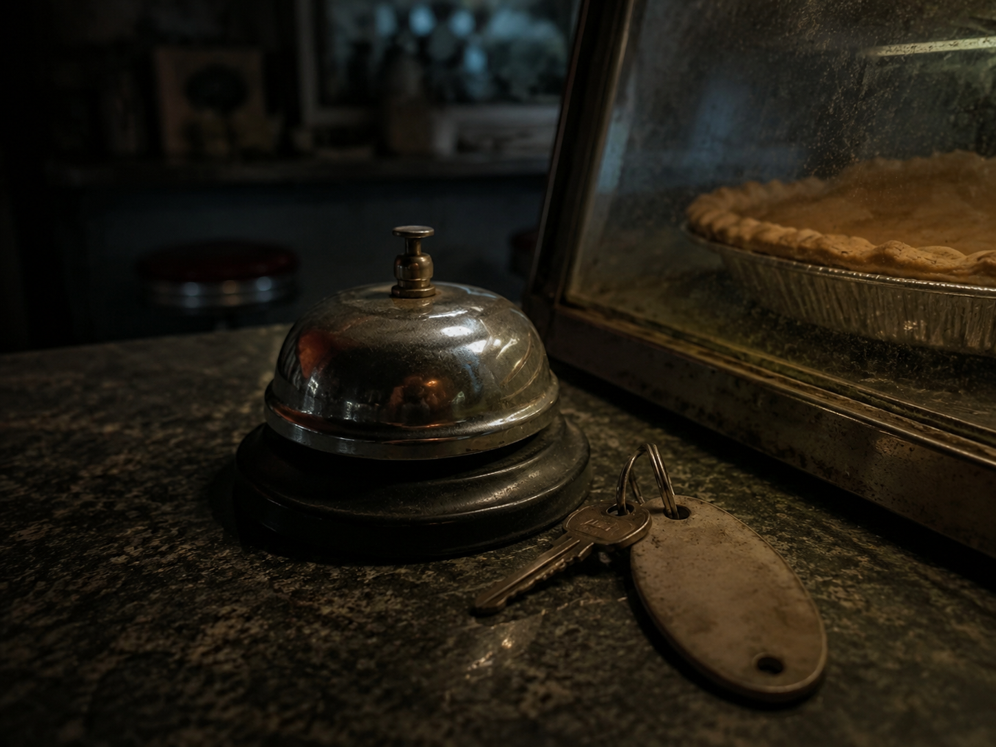 Service bell beside dusty diner pie case