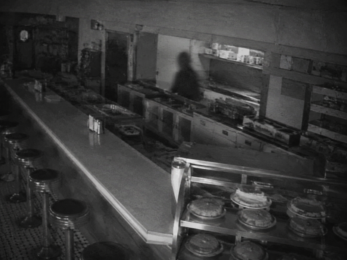Security view of empty diner counter and kitchen pass