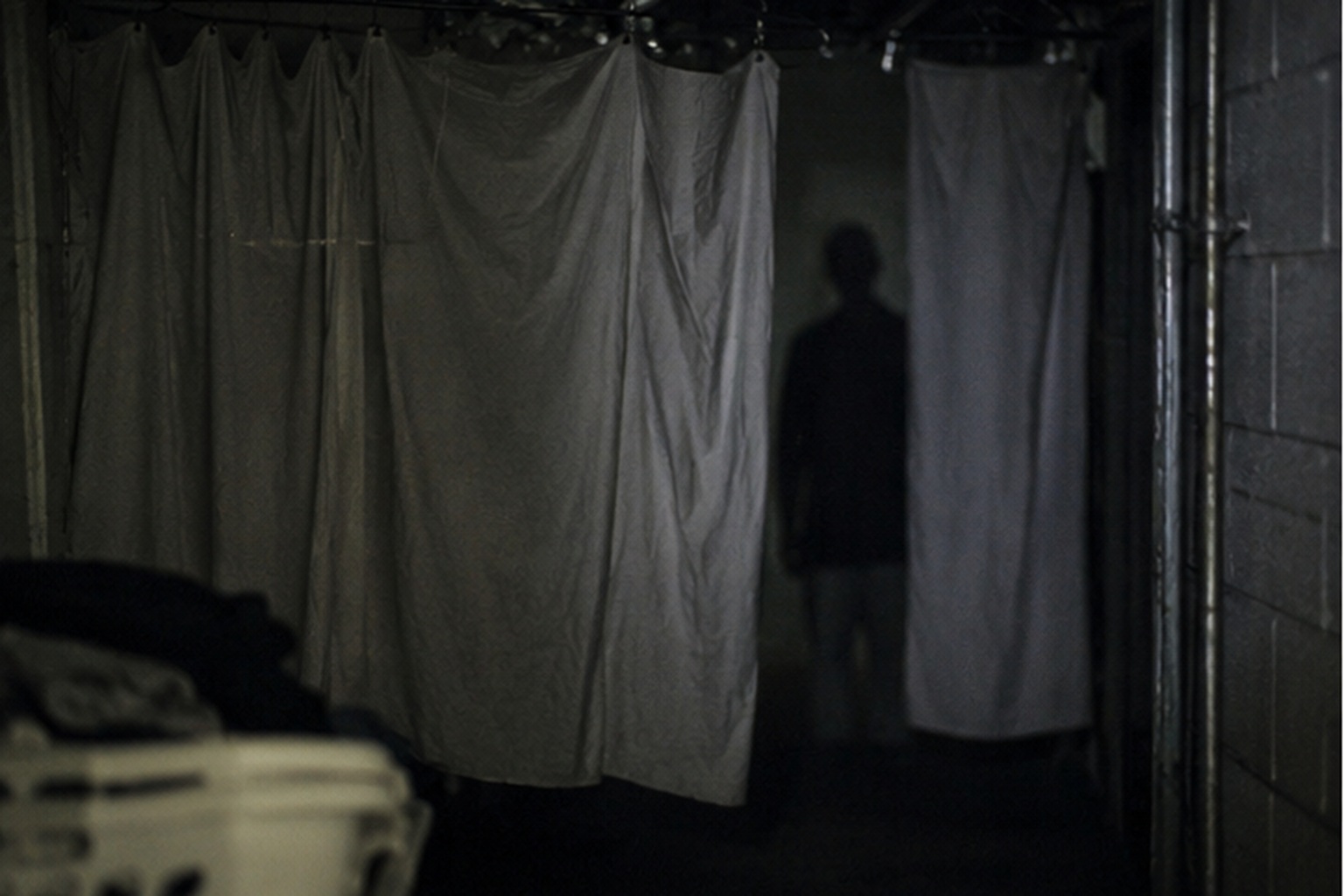 Behind the hanging service towels, the footage showed a featureless figure where no person should have been standing.