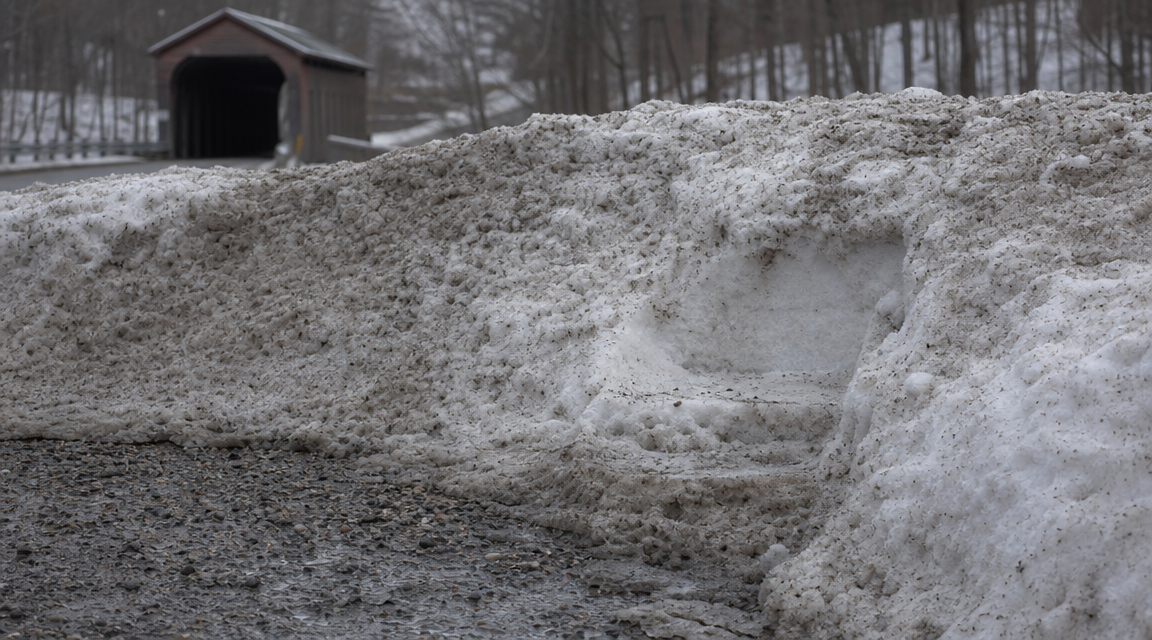Wide compacted mark on a snowplow berm