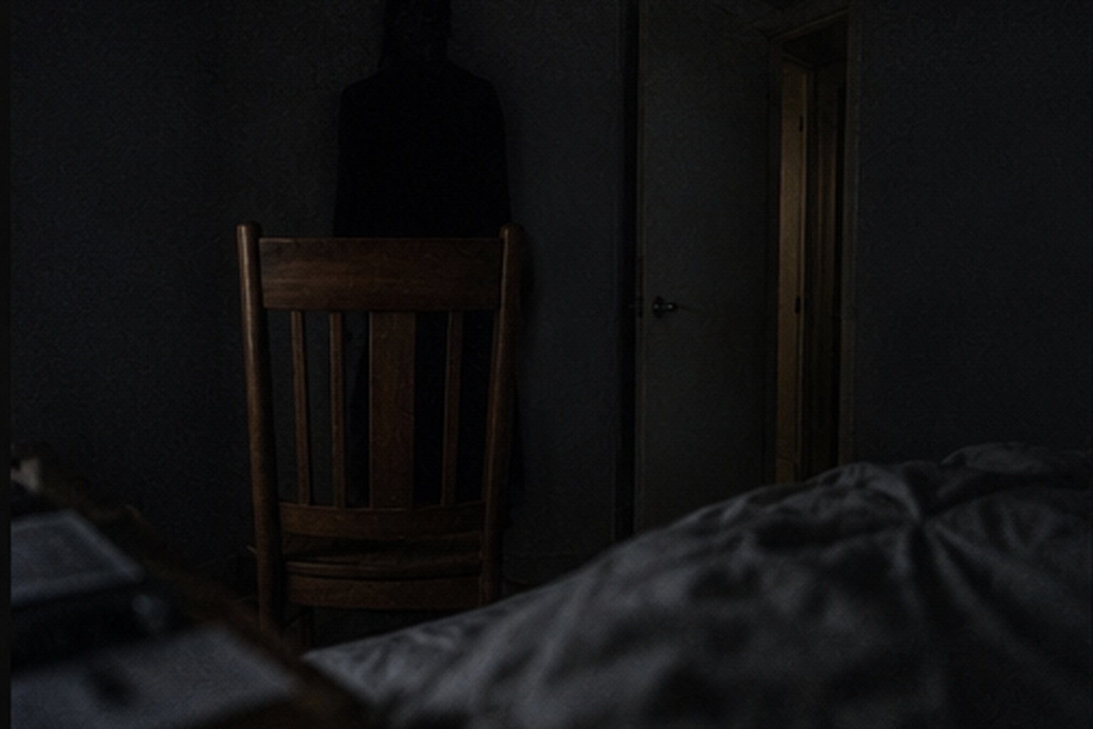 Dark apparition behind a bedroom chair