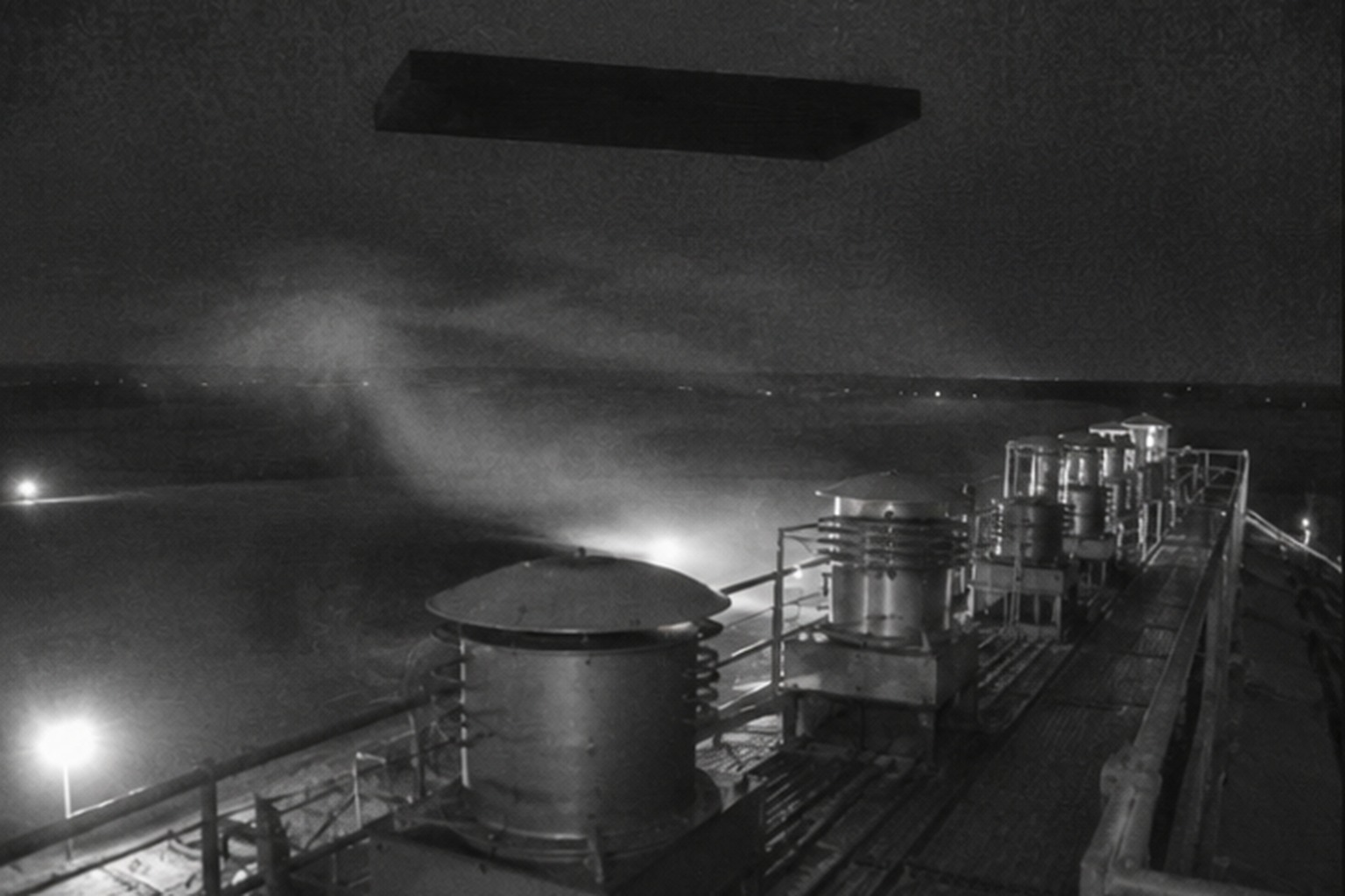 Black rectangle hovering above silo vents