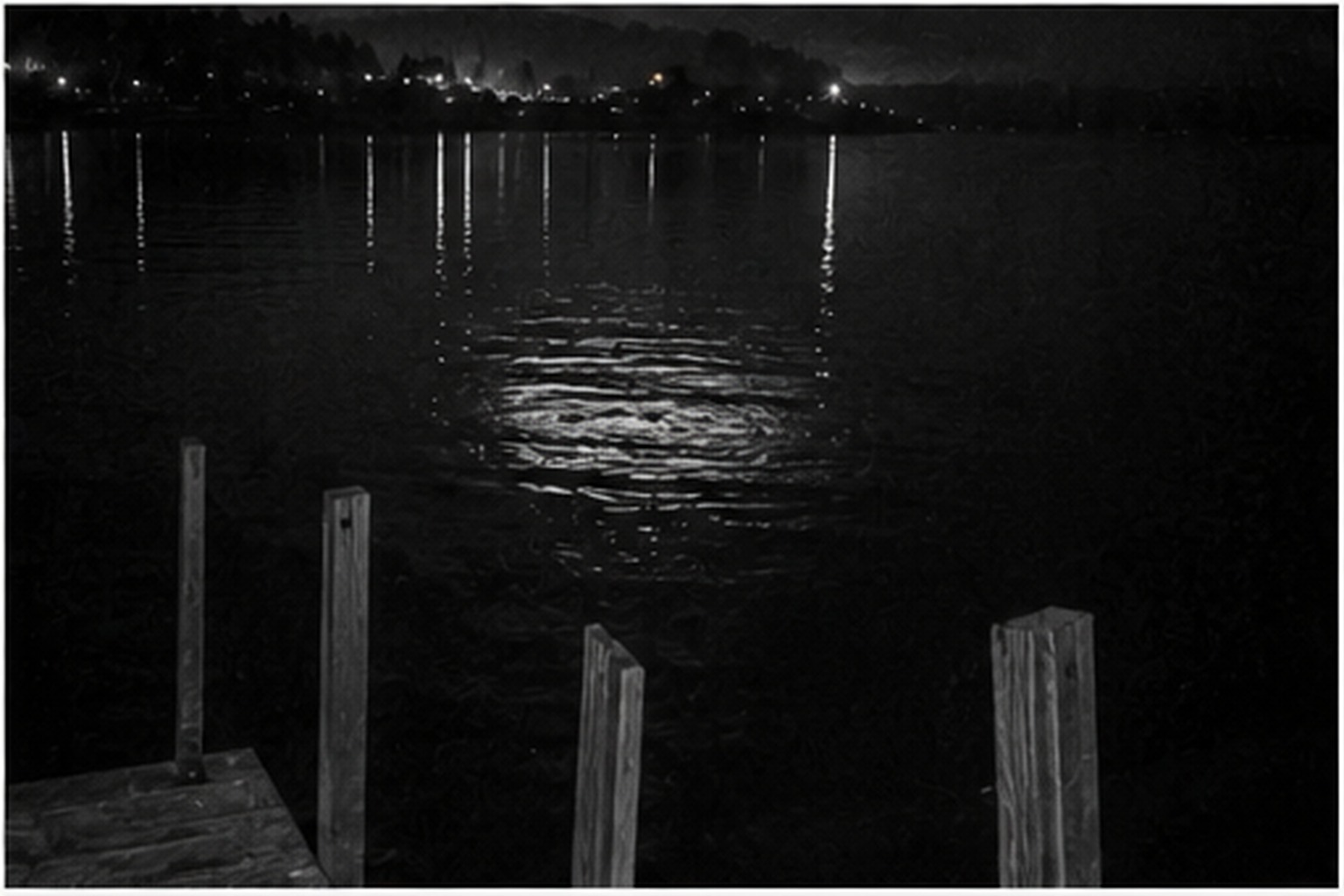 Oval light reflected in rippling lake water