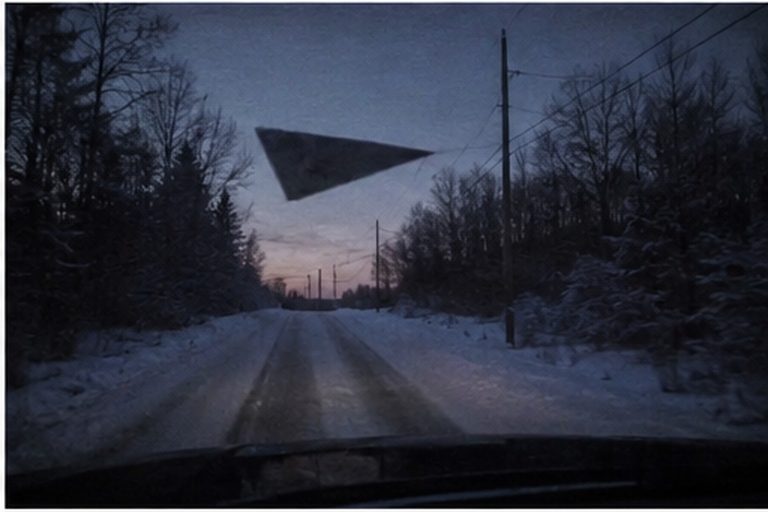 Black triangle hovering above a snowy mail route