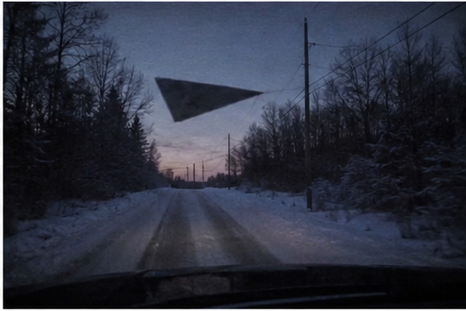 Black triangle hovering above a snowy mail route