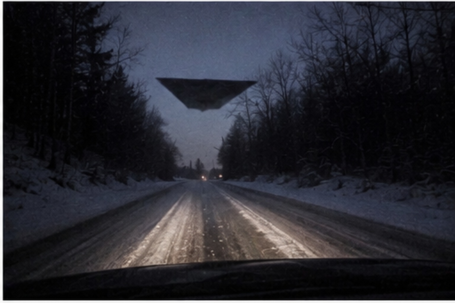 Mail truck windshield facing a snow road