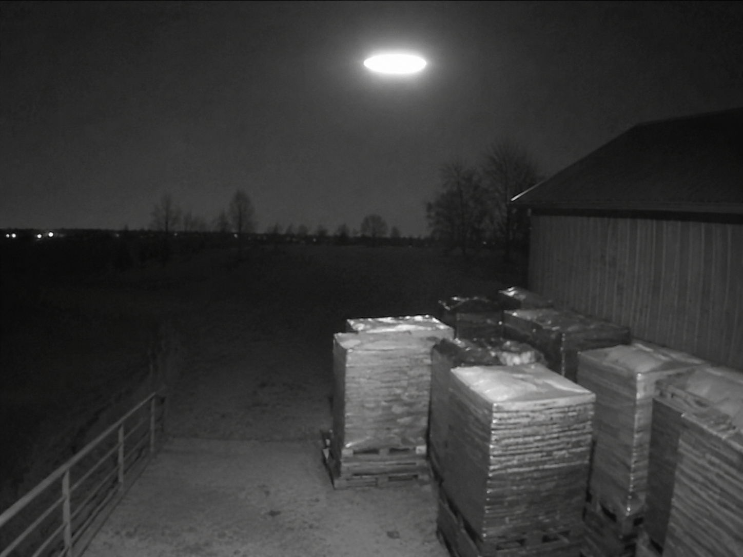 Oval light above feed pallets on security camera