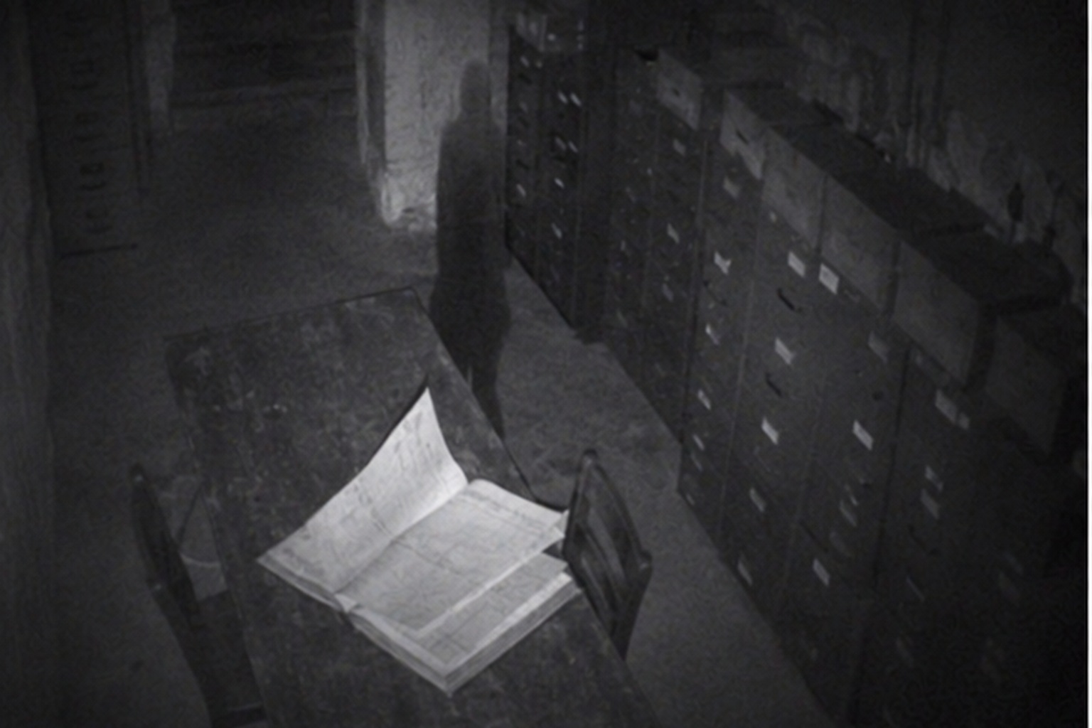 The overnight camera did not show a visitor, only pages moving in the dark record room.