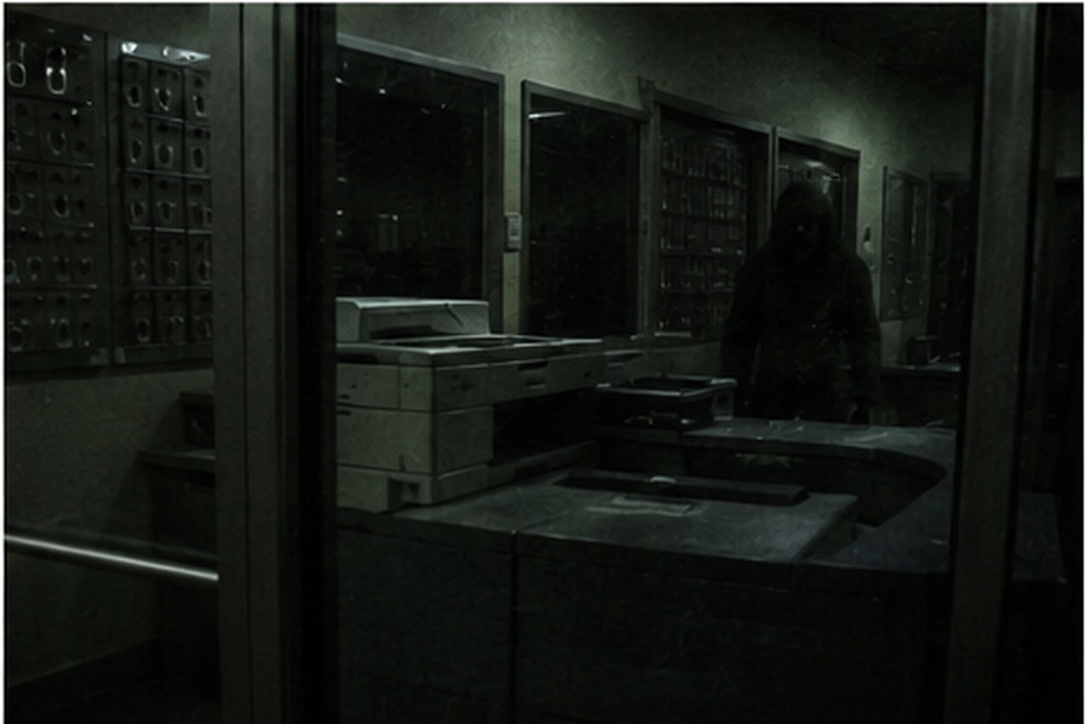 Dark figure reflected in storage office glass