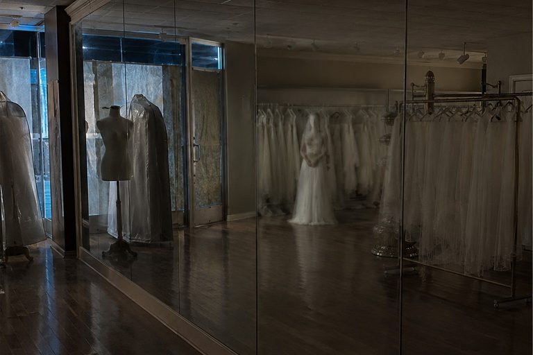 The Closed Bridal Shop Mirror Photo Showed A White-Dressed Figure Behind The Veil Racks reconstructed scene 1