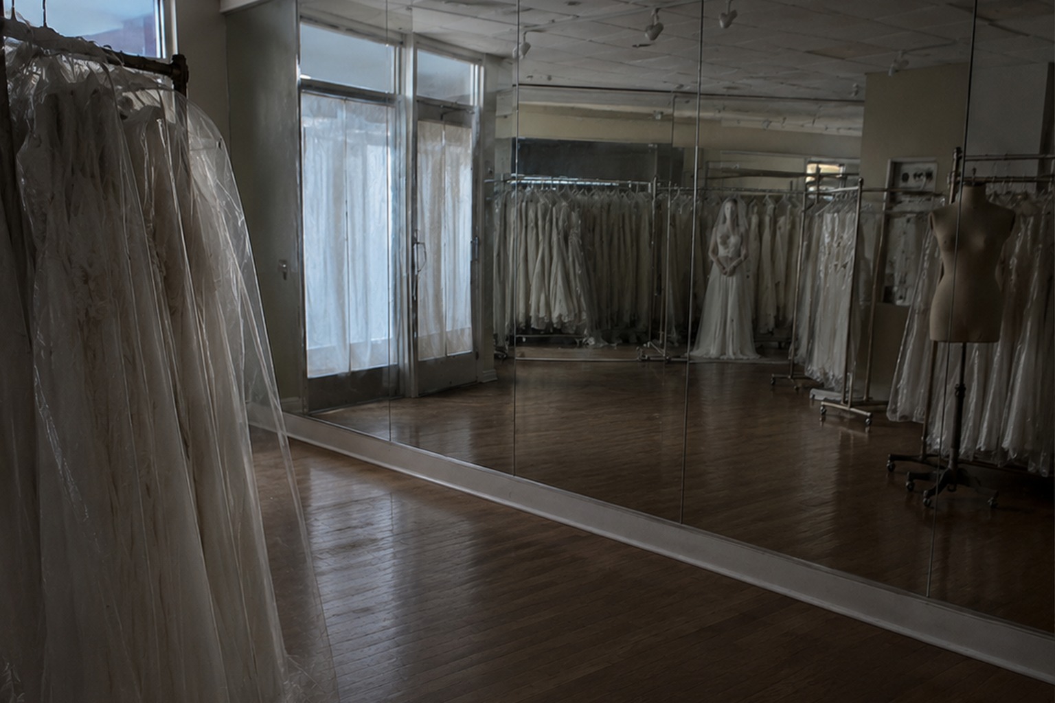 The Closed Bridal Shop Mirror Photo Showed A White-Dressed Figure Behind The Veil Racks reconstructed scene 2