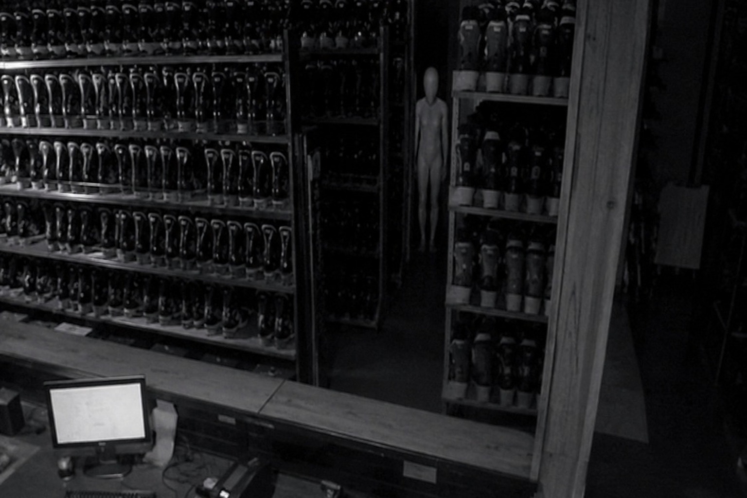 The Closed Ski Rental Counter Camera Showed A White Figure Behind The Boot Wall reconstructed scene 1