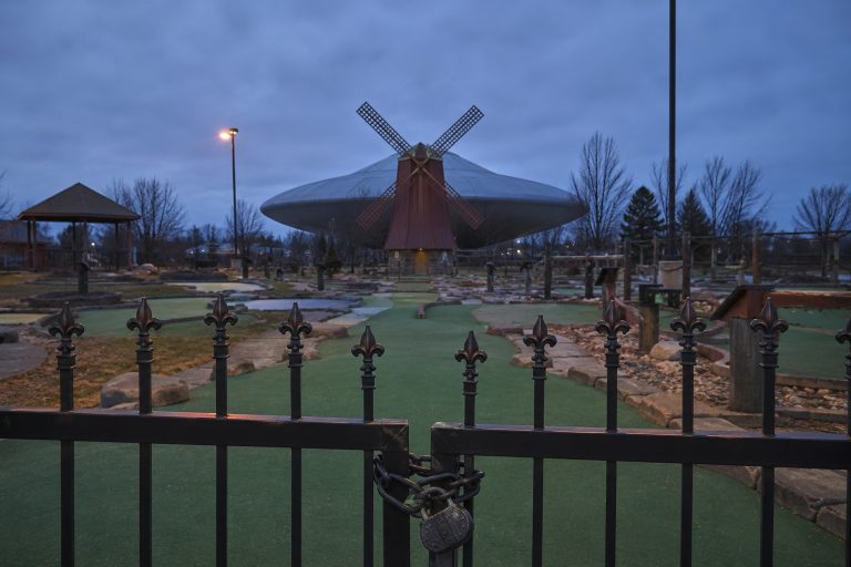 Editorial recreation of the A Dull Saucer Hung Behind Closed Mini Golf Windmill During The Power Flicker story, image 1.