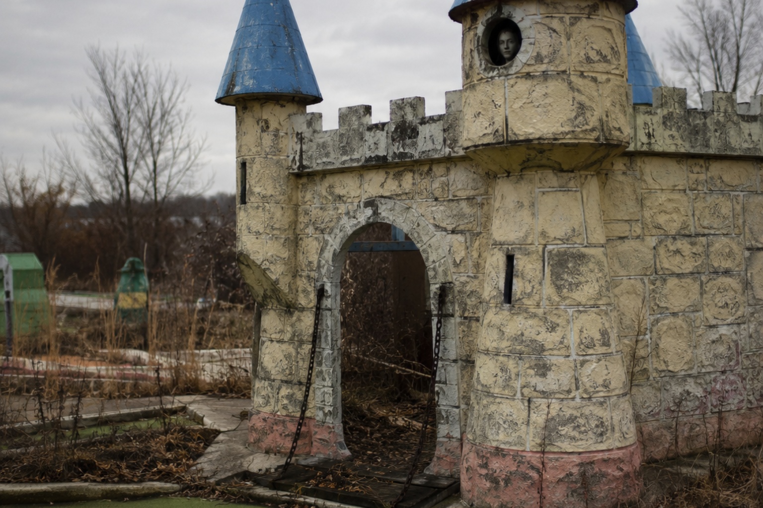 The Abandoned Mini Golf Castle Window Showed A Face Behind The Painted Turret - article image 1