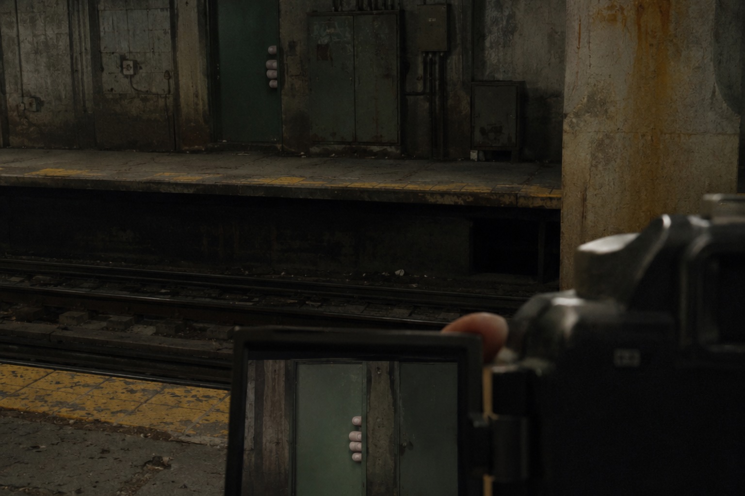 Editorial recreation of the Abandoned Subway Platform Mirror Photo Showed Fingers Curled Around The Signal Door story, image 1.