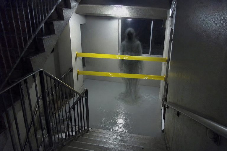 Editorial recreation of the Apartment Stairwell Camera Showed An Elderly Man Waiting On A Landing Sealed With Wet Paint Tape story, image 1.