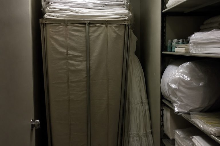 Editorial recreation of the Closed Motel Linen Closet Security Photo Showed A White Dress Behind The Sheet Cart story, image 1.
