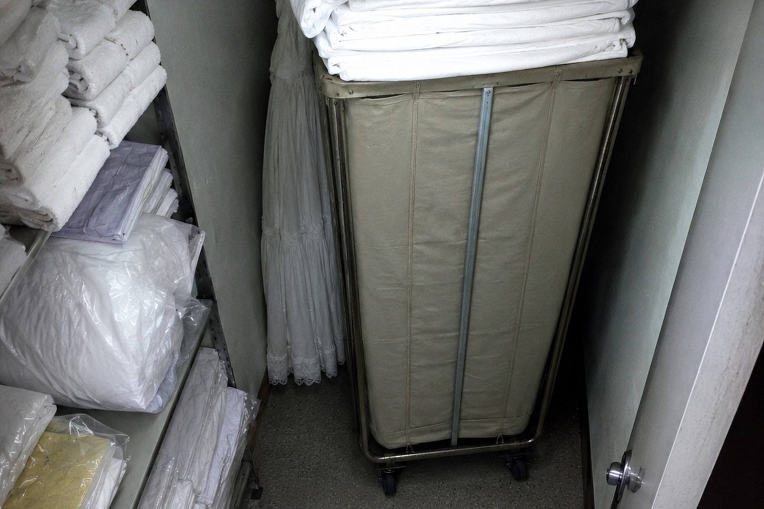 Editorial recreation of the Closed Motel Linen Closet Security Photo Showed A White Dress Behind The Sheet Cart story, image 3.