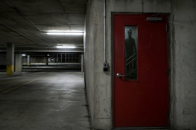 The Closed Parking Garage Camera Showed A Shadow Figure Waiting Behind The Fire Door
