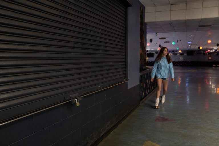 Editorial recreation of the Closed Roller Rink Camera Showed A Girl Skating Past The Dark Snack Bar story, image 1.
