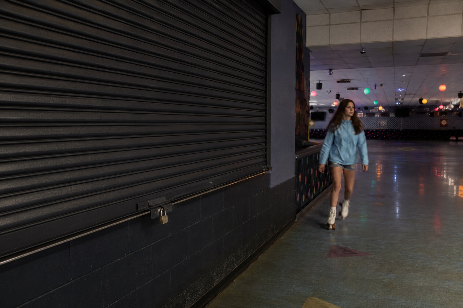 Editorial recreation of the Closed Roller Rink Camera Showed A Girl Skating Past The Dark Snack Bar story, image 1.