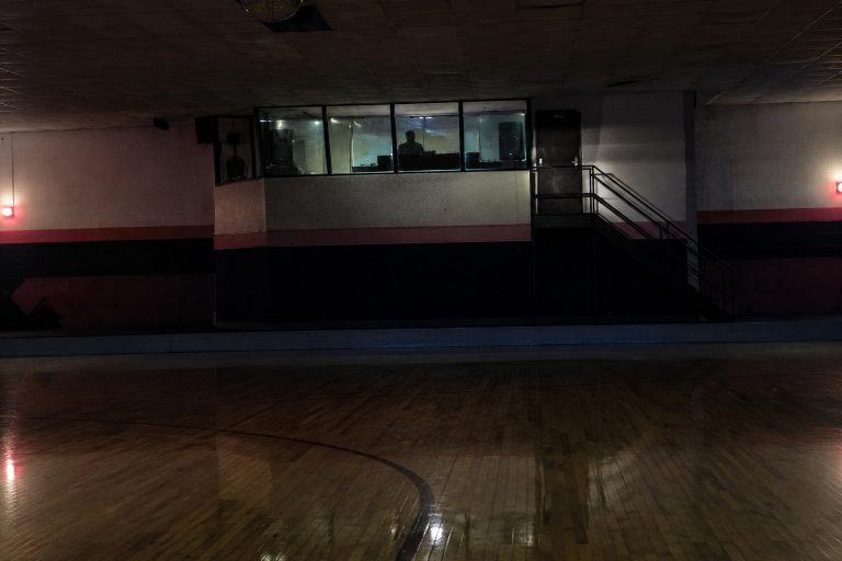 Editorial recreation of the Closed Roller Rink Ceiling Camera Showed A Pale Figure Sitting In The DJ Booth After Lockup story, image 1.