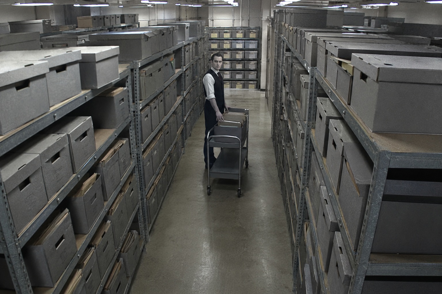 Editorial recreation of the County Courthouse Records Room Camera Showed A Pale Clerk Standing Between The Archive Shelves After Closing story, image 1.