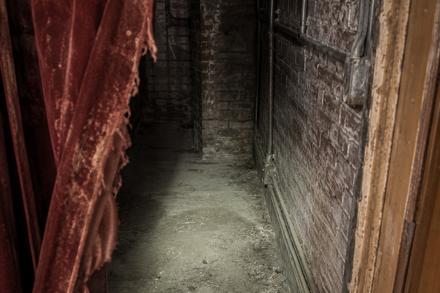 Editorial recreation of the Empty Community Theater Balcony Photo Showed A White Dress Behind The Torn Curtain story, image 3.