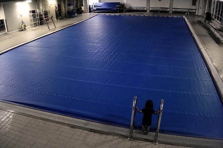 Editorial recreation of the Empty Indoor Pool Camera Showed A Child-Sized Figure Standing At The Deep End Ladder story, image 1.