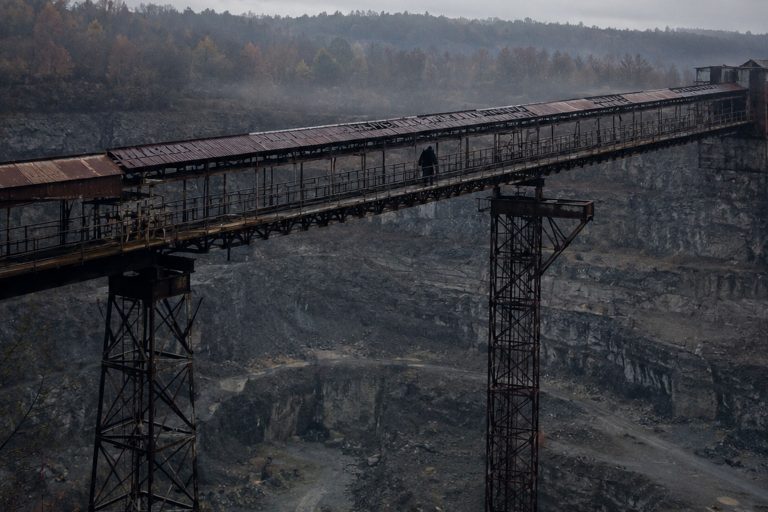 Editorial recreation of the Old Quarry Conveyor Photo Showed A Broad Hairy Figure Crossing The Rusted Catwalk story, image 1.
