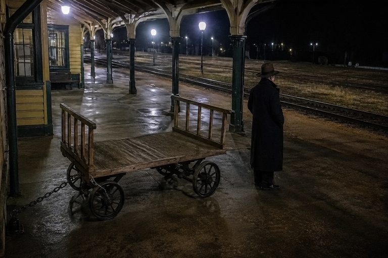 Editorial recreation of the Old Train Depot Platform Camera Showed A Shadow Passenger Waiting Beside The Baggage Cart story, image 1.