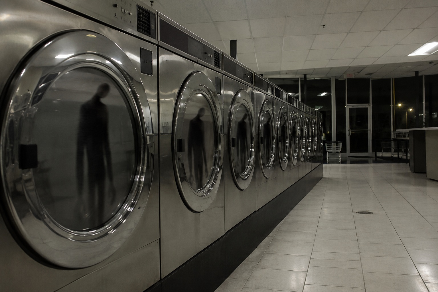 Editorial recreation of the Overnight Laundromat Camera Showed A Faceless Man Reflected In Every Washer Door story, image 1.