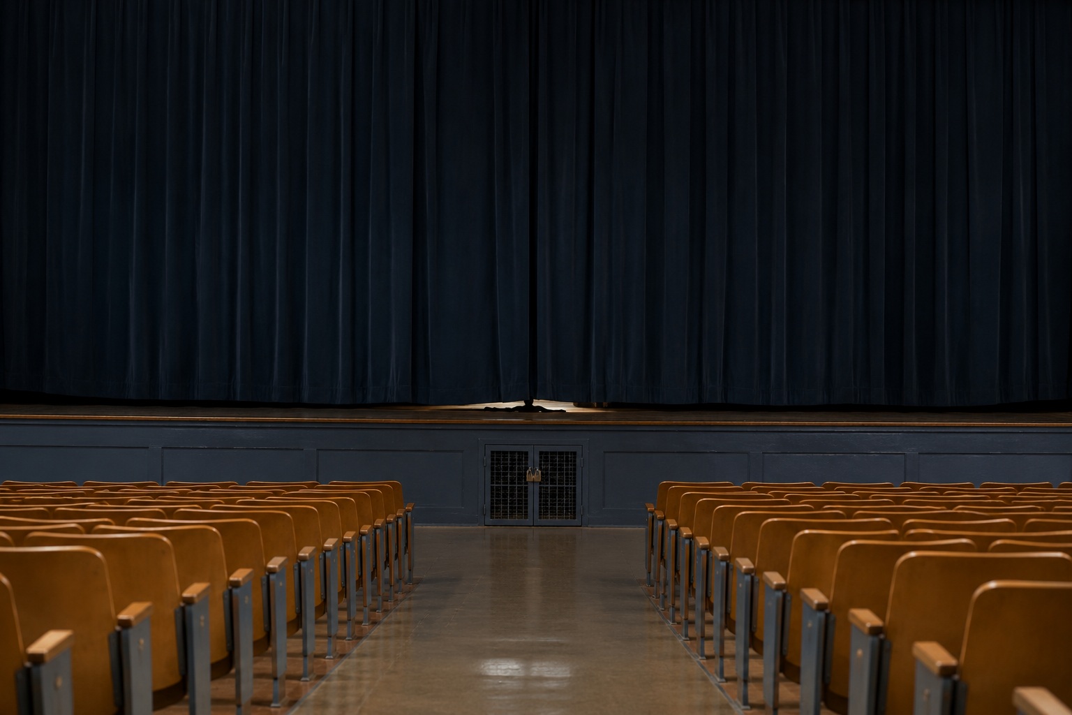 Editorial recreation of the School Auditorium Was Empty But Someone Was Sitting Under The Stage Curtain story, image 1.