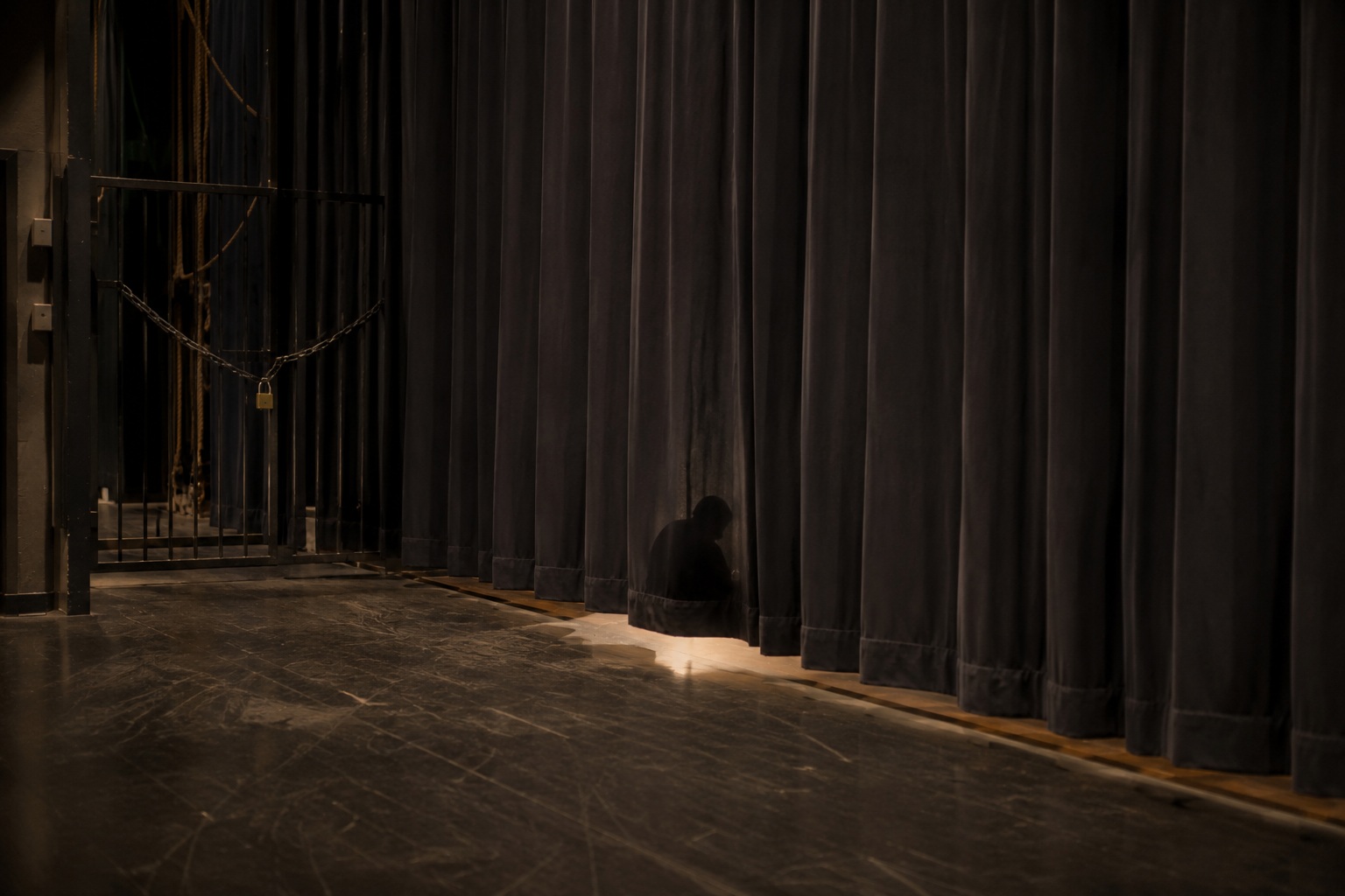 Editorial recreation of the School Auditorium Was Empty But Someone Was Sitting Under The Stage Curtain story, image 4.