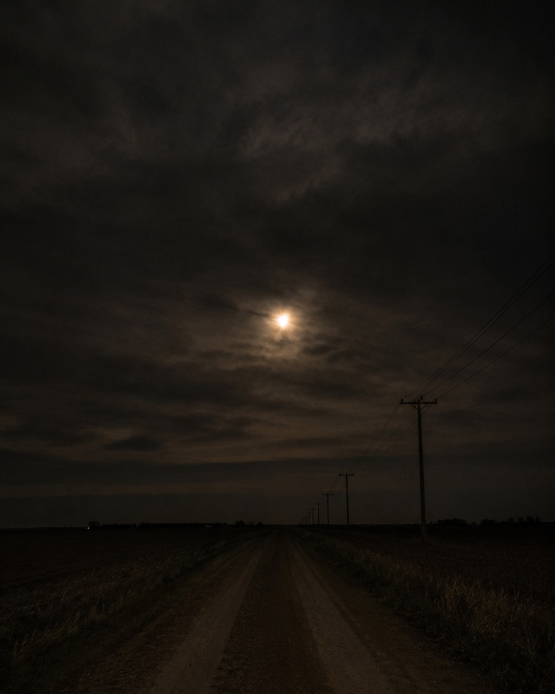 Editorial illustration of distant lights over a dark horizon with no clear distance cues.