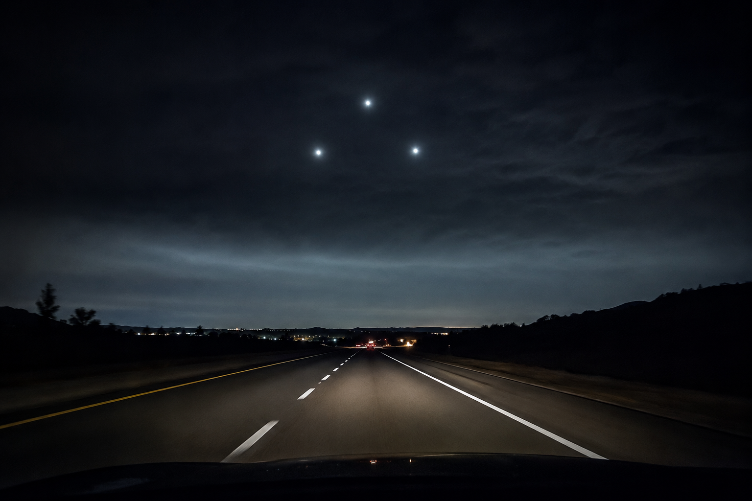 Cinematic editorial reconstruction of a black triangle UFO report over a highway